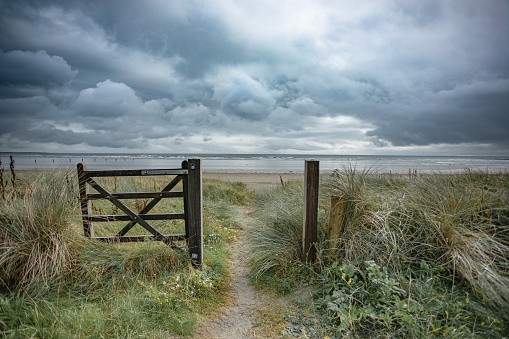 Moody skies and gateway to moody beach