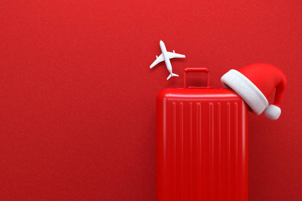 istock Christmas Travel Concept with Suitcase on Red Background 1185266840
