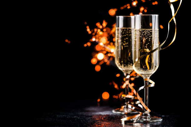 istock champagne glasses with sparkles 1185267110