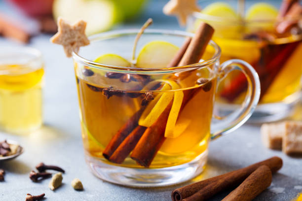 istock Apple mulled cider with spices in glass cup. Grey stone background. Close up. 1185270852