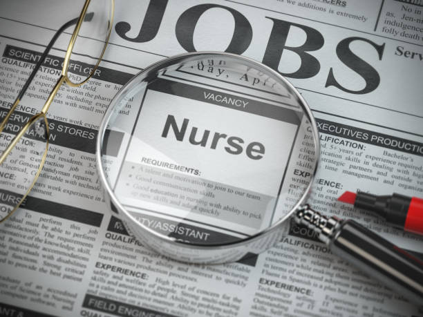 nurse vacancy in the ad of job search newspaper with loupe. - job listing imagens e fotografias de stock