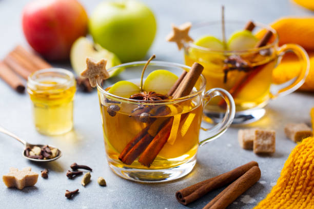 istock Apple mulled cider with spices in glass cup. Grey stone background. Close up. 1185270925