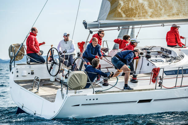 Sailing crew on sailboat on regatta Sailing crew on sailboat on regatta in action. Models and event regatta property released. regatta stock pictures, royalty-free photos & images