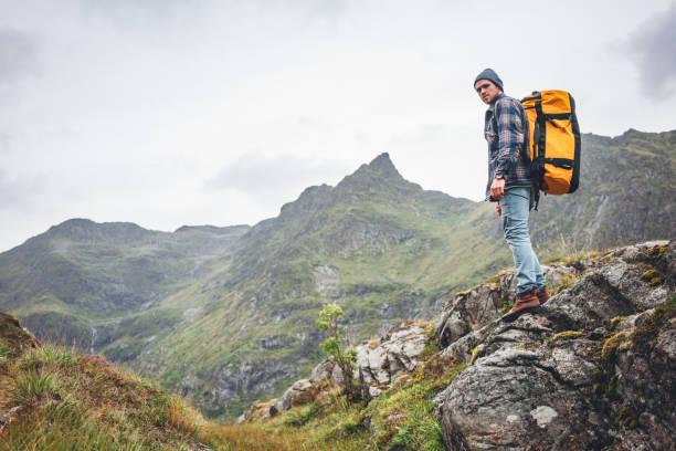 istock Alone man expeditor wearing professional backpack standing  mountain looking away. Lifestyle adventure vacation 1185272589