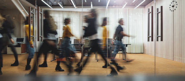 businesspeople walking at modern office. group of business employees at coworking center. motion blur. concept work process. wide image - movimento imagens e fotografias de stock