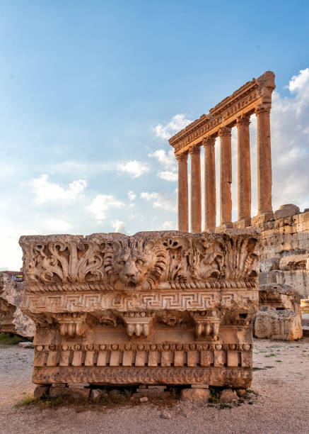 The six columns of the temple of Zeus at sunset seen behind part of the fregio decorated with a lion head. Baalbek in Lebanon