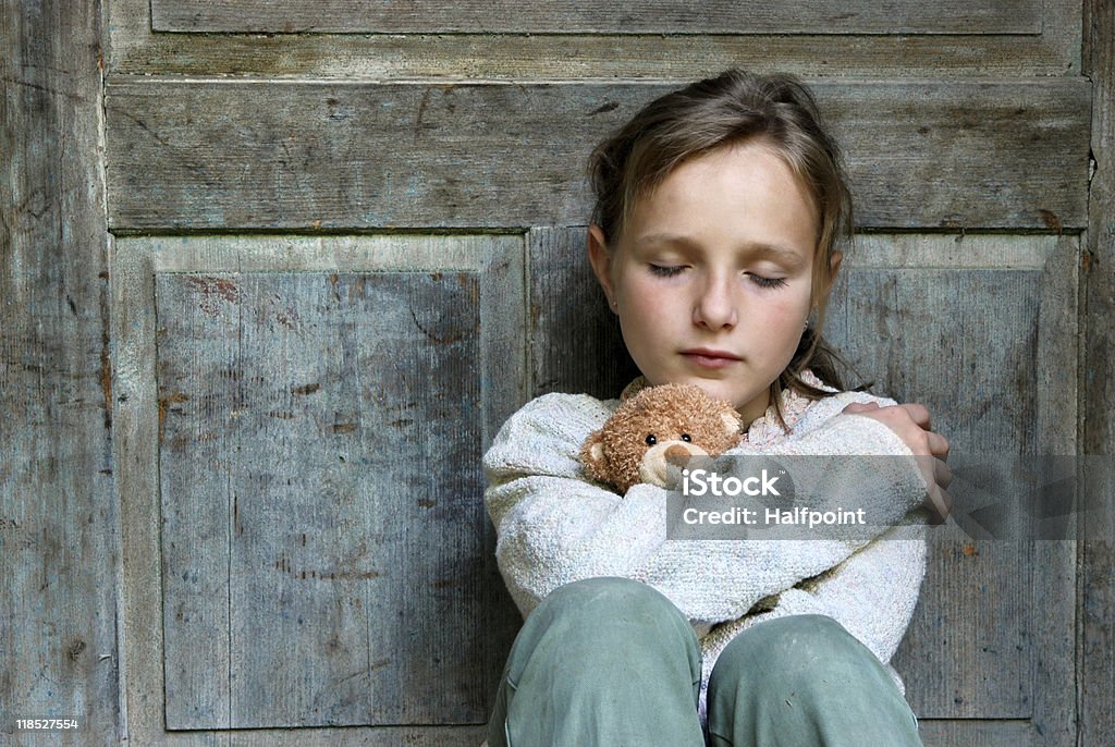 Sad little girl with teddy bear  Street Child Stock Photo