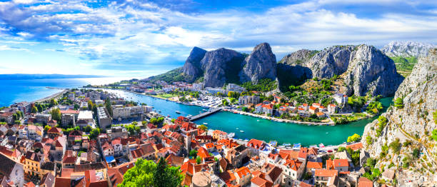 Landmarks of Croatia - impressive Omis town surrounded with gorges, over Cetina river Omis town famous for climbing and rafting activities in Croatia dalmatia region croatia photos stock pictures, royalty-free photos & images