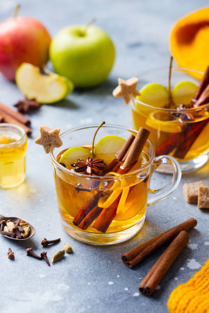 istock Apple mulled cider with spices in glass cup. Grey stone background. 1185278487