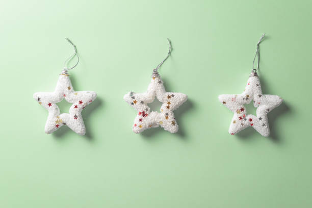 istock white Christmas star ornament on sparce green mint background 1185284460