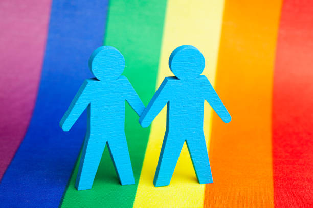 Two GAY men holding hands. LGBT background rainbow flag