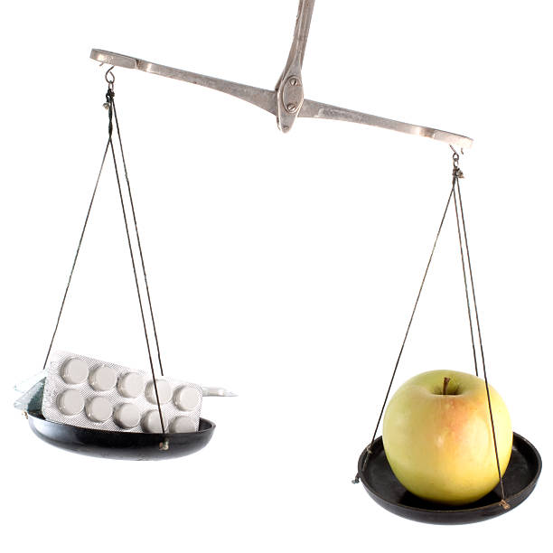 istock Laboratory balance with pill and apple 118528993