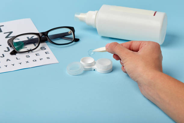 istock Flat composition with contact lenses, table for eye examination. Accessories for ophthalmologists. Glasses and lenses for vision correction on a blue background 1185290905