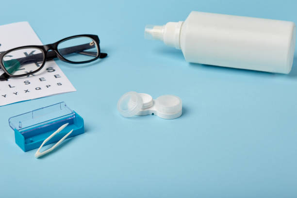 istock Flat composition with contact lenses, table for eye examination. Accessories for ophthalmologists. Glasses and lenses for vision correction on a blue background 1185290912