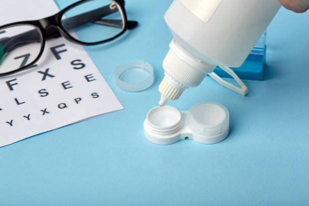 istock Flat composition with contact lenses, table for eye examination. Accessories for ophthalmologists. Glasses and lenses for vision correction on a blue background 1185290924