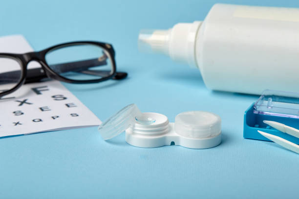 istock Flat composition with contact lenses, table for eye examination. Accessories for ophthalmologists. Glasses and lenses for vision correction on a blue background 1185290929
