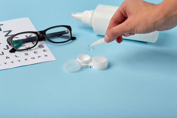istock Flat composition with contact lenses, table for eye examination. Accessories for ophthalmologists. Glasses and lenses for vision correction on a blue background 1185291107