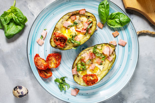 istock Keto diet: Avocado with ham, quail eggs, cheese on concrete background 1185292382