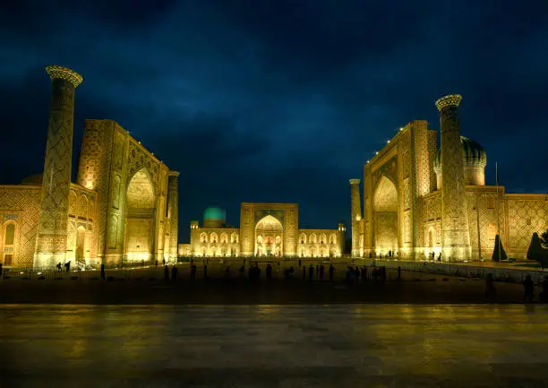 Panoramic view of the world famous Registan Square in the city of Samarkand. The buildings were build from King Timur Tamerlan in the 14th century when the city of Samarkand became the capital of the Timurid Empire. The full ensemble of the Registan Square is listed as UNESCO World Heritage Site. Samarkand was one of the most important oasis and place of caravanserais at the Great Silk Road.