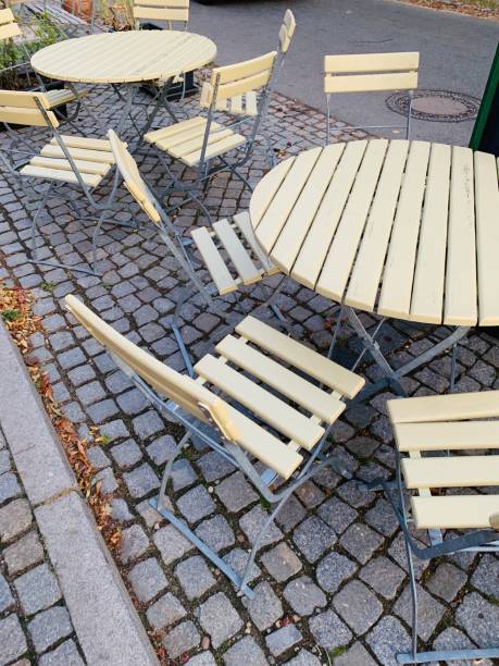 istock Outdoor empty cafe tables and chairs 1185292586