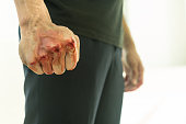 Aggressive violent man in a fight, with a blood fist.
