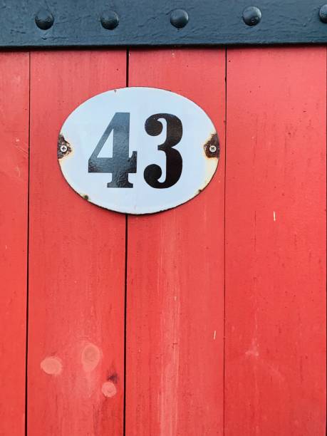 istock House number 43 on red wooden wall 1185293619