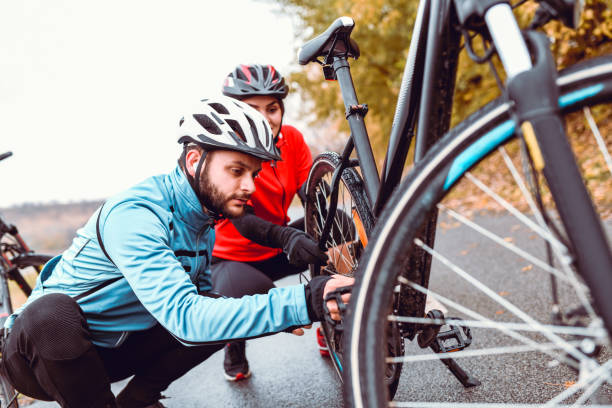 istock Cyclist Couple Fixing Bike While Taking A Break 1185293651