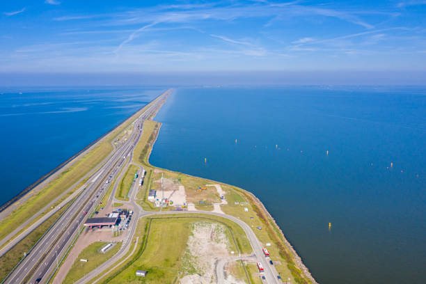 Afsluitdijk, a major dam and causeway in the Netherlands, runs from Den Oever in North Holland to village of Zurich in Friesland province, damming off the Zuiderzee, salt water inlet of the North Sea. stock photo