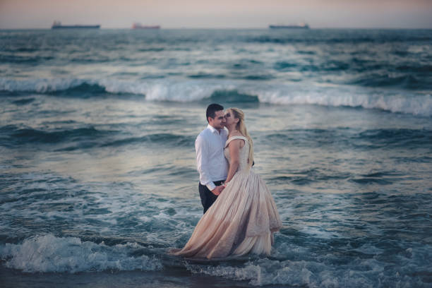 istock bride and groom at the sea 1185296116