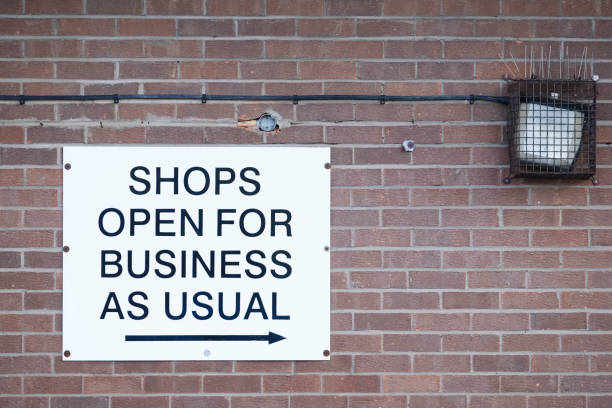 istock Shops open for business as usual sign 1185298797