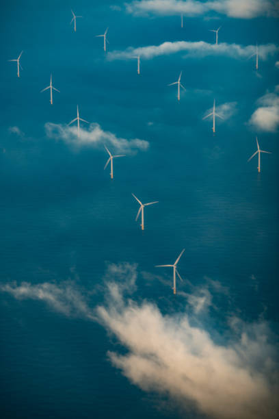 Rows of wind turbines at sea stock photo