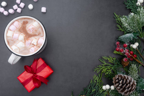 istock Hot chocolate mugs with marshmallows and christmas gift boxes. Flat lay with fir branches. Gray background. Copy space. 1185299317