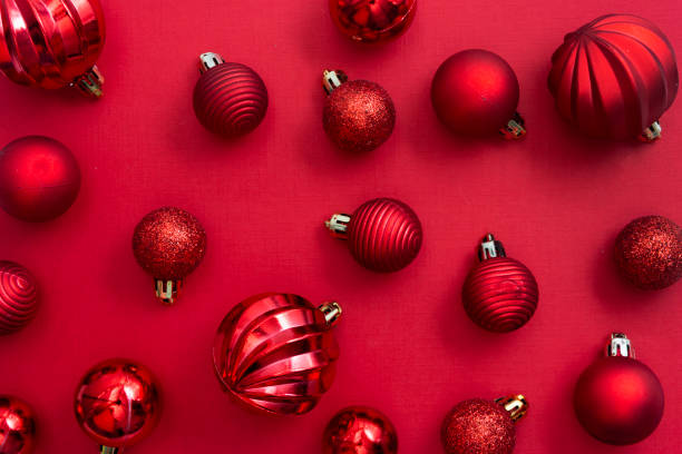 istock Christmas red background pattern with red baubles and glitter with copy space. Winter christmas frame border. 1185300749
