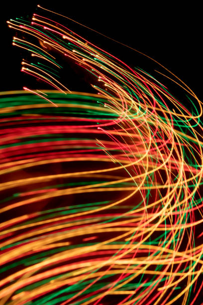 istock Glowing light trails - LED light painting (multi colored) 1185301471