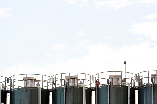 Gas tanks, sky background with copy space, horizontal composition