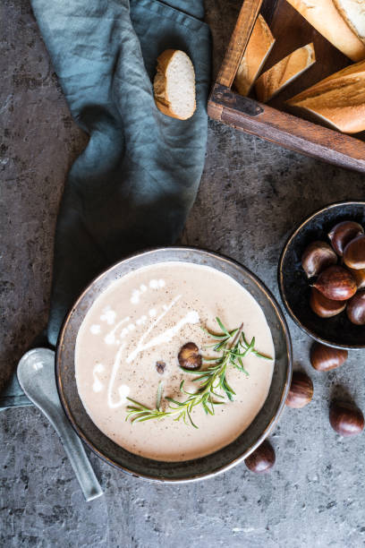 Creamy chestnut soup with sour cream in a ceramic bowl