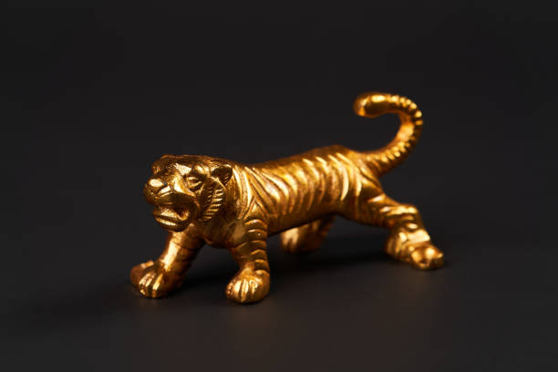 istock Golden tiger toy on black background with copy space. 1185305970