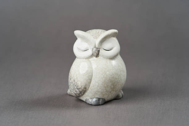 istock White owl toy over grey background with copy space 1185305977
