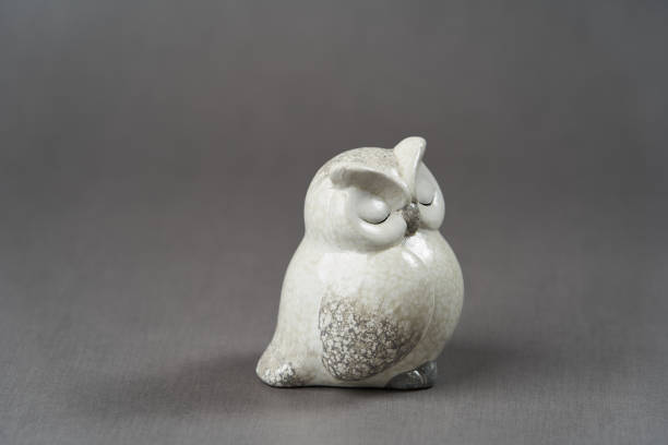 istock White owl toy over grey background with copy space 1185305983