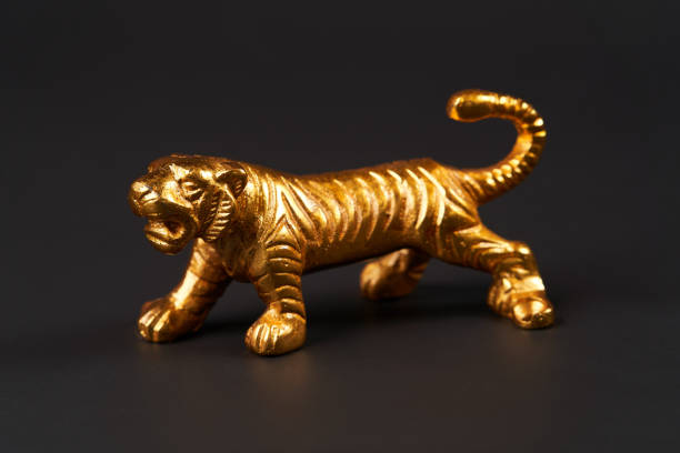 istock Golden tiger toy on black background with copy space. 1185306000
