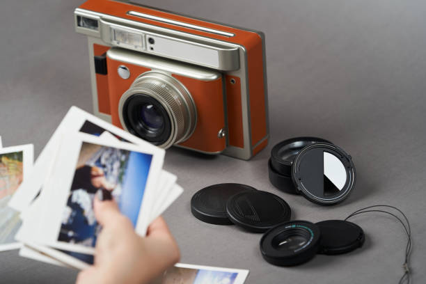 istock Retro camera and old photo film rolls on gray background 1185306003