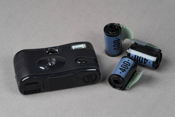 istock Retro camera and old photo film rolls on gray background 1185306007