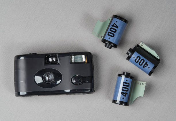 istock Retro camera and old photo film rolls on gray background 1185306008
