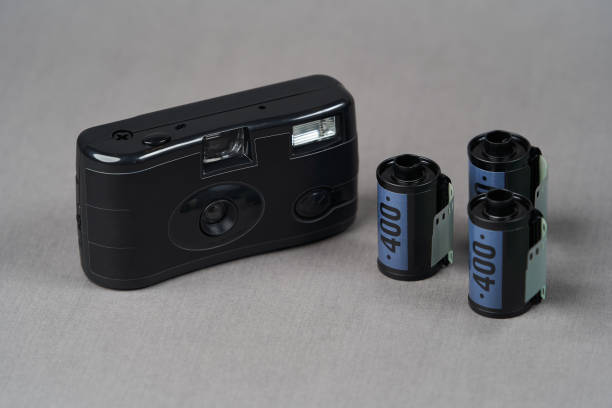 istock Retro camera and old photo film rolls on gray background 1185306010