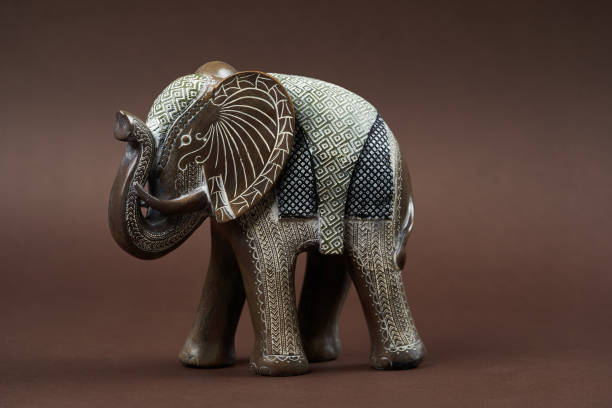 istock Decorative elephant toy on brown background with copy space 1185307133