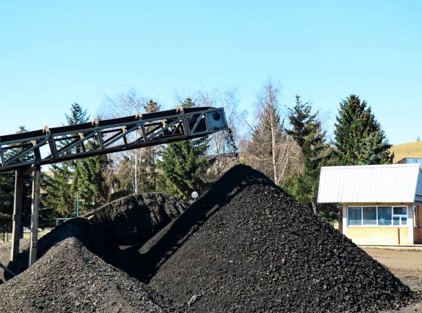 istock Coal  falling from the moving belt conveyor into the big pile 1185308167