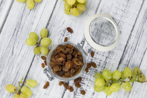 istock Portion of fresh Raisins on an old wooden table 1185309692