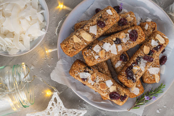istock Granola bar. Healthy snack. Cereal granola bar with nuts, fruit, coconut and cranberries on a christmas table. Top view 1185310165
