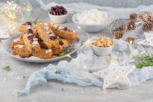 istock Granola bar. Healthy snack. Cereal granola bar with nuts, fruit, coconut and cranberries on a christmas table 1185310177