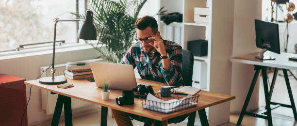 Man using laptop in his office. stock photo